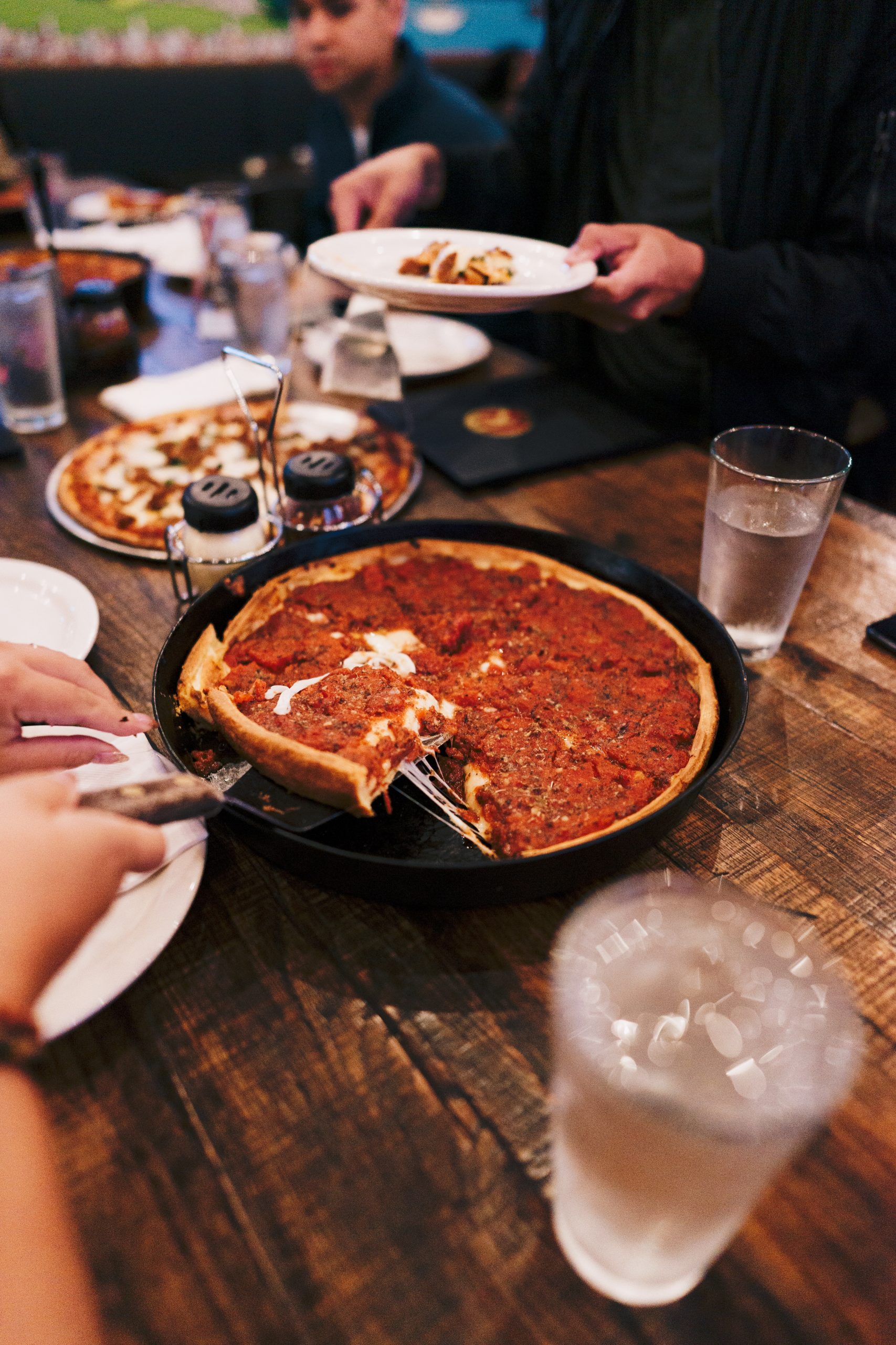 deep dish pizza being served